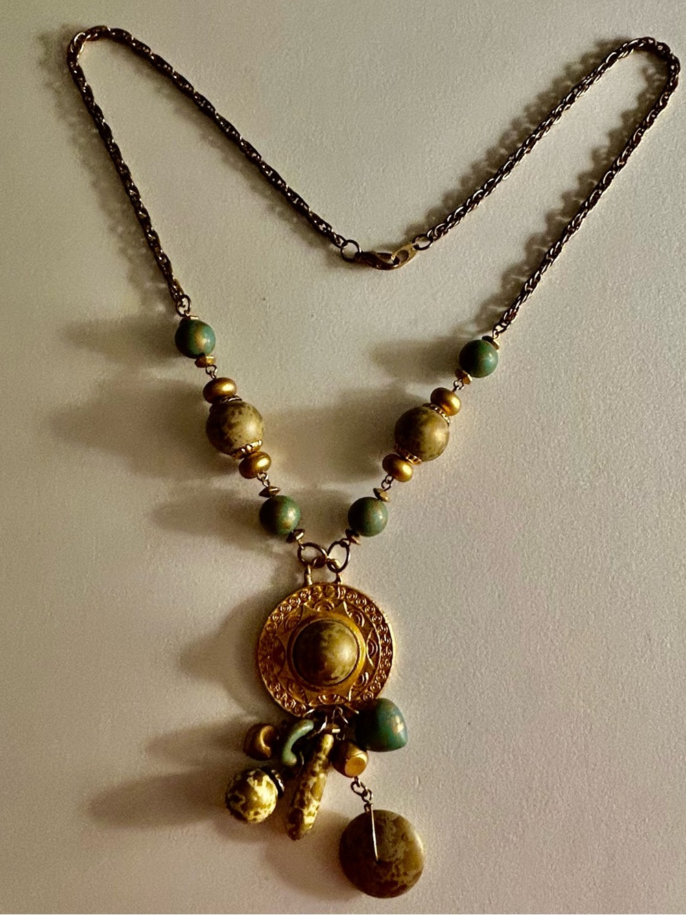 Necklace Vintage Gold embossed Sun Disk, Aqua, gold,& cream painted charms beads